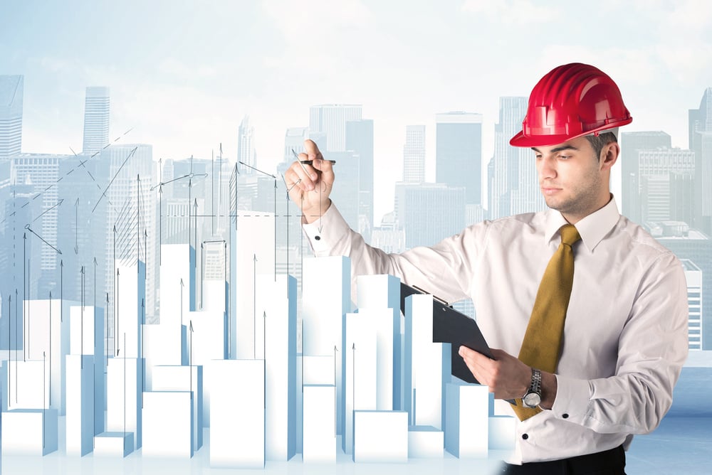 A happy construction worker drawing a city with white, plain buildings, using arrows and angles